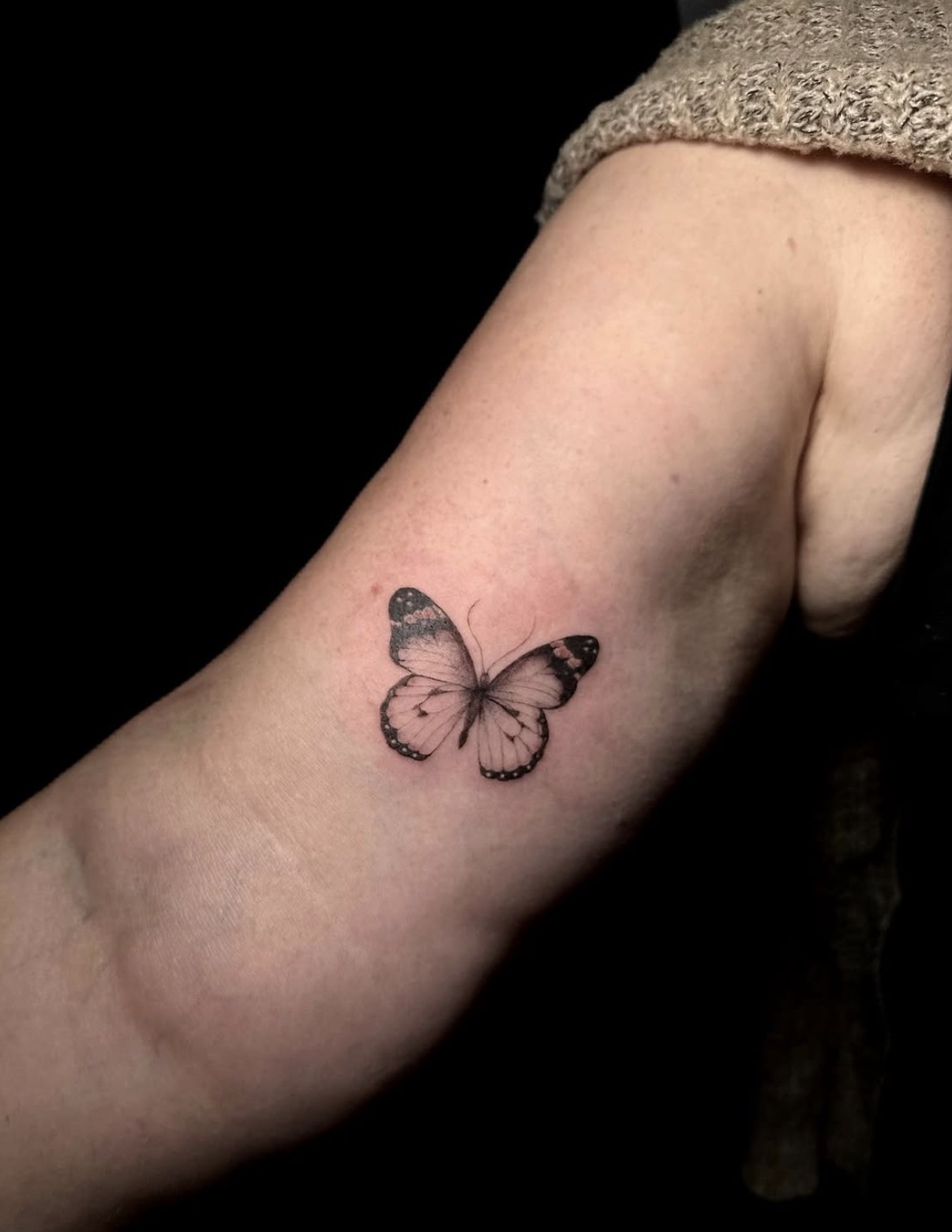 Kleiner Schmetterling am Arm